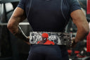 Person wearing a custom Spider-Man anime powerlifting lever belt during a gym workout, showcasing a personalised leather lifting belt in India.