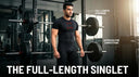 A powerlifting athlete standing in a gym wearing a black full-length singlet with text callouts highlighting full-length coverage and competition approval.