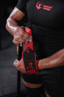Athlete wearing Griffin Gears wrist wraps while preparing for a heavy weightlifting session in the gym.