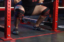 Athlete performing a heavy squat using powerlifting knee wraps in India for maximum support, stability and strength.